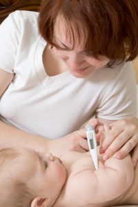 Small baby with mother taking temperature