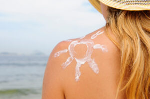 girl_with_sun_drawn_on_shoulder_in_sun_lotion