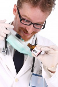 homeopathy and flu vaccine doctor preparing toxic injection